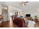 Open-concept living room features hardwood floors, a ceiling fan, and seamless flow to the kitchen area at 1647 Sabastian Ne Pt, Atlanta, GA 30329