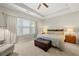 The primary bedroom includes a ceiling fan, tray ceiling, bench and two windows at 1647 Sabastian Ne Pt, Atlanta, GA 30329