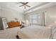 Large primary bedroom offers natural light, hardwood dresser, and seating area at 1647 Sabastian Ne Pt, Atlanta, GA 30329