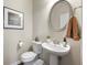 This half-bathroom includes white fixtures, oval mirror, pendant lighting and neutral paint at 1647 Sabastian Ne Pt, Atlanta, GA 30329