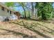 View of the home's backyard showing large trees, grass and exterior of the house at 2240 Polar Rock Sw Ave, Atlanta, GA 30315