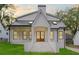 Charming white farmhouse with a black metal roof, complemented by a well-manicured lawn at 3353 Hemphill St, Atlanta, GA 30337