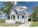Elegant white home with a modern design, highlighted by dark-framed windows, gabled roof, and inviting front entrance at 3353 Hemphill St, Atlanta, GA 30337