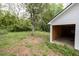 An open garage adjoins the white exterior of the home with a nice yard at 3353 Hemphill St, Atlanta, GA 30337