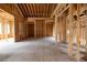 Unfinished Living room showing exposed wood framing, pre-installed wiring, and open room concept at 3353 Hemphill St, Atlanta, GA 30337