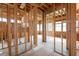 Unfinished living room highlighting exposed wood framing, window placement, and overall layout of the space at 3353 Hemphill St, Atlanta, GA 30337