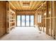 Unfinished living room features an open floor plan with exposed wood framing and large glass doors at 3353 Hemphill St, Atlanta, GA 30337