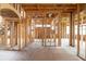 Exposed wood framing of a new home's living room featuring open spaces, staircase framework, and natural lighting at 3353 Hemphill St, Atlanta, GA 30337