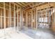 Unfinished living room featuring exposed wood framing, plumbing, and electrical pre-installation at 3353 Hemphill St, Atlanta, GA 30337