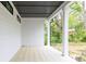 Inviting outdoor porch with herringbone brick flooring, offering a stylish space to enjoy the surrounding greenery and fresh air at 3353 Hemphill St, Atlanta, GA 30337