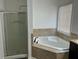 Spacious bathroom with a soaking tub, shower, and large window for plenty of natural light at 615 Old Johnson Rd, Lawrenceville, GA 30045