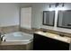 Bright bathroom with a corner soaking tub, double vanity, and tile accents at 615 Old Johnson Rd, Lawrenceville, GA 30045