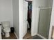 Bathroom featuring a toilet, shower stall, and an open closet for additional storage space at 615 Old Johnson Rd, Lawrenceville, GA 30045