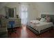 Bedroom featuring light walls, wood floors, dresser and neutral decor at 615 Old Johnson Rd, Lawrenceville, GA 30045