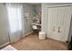 Bright bedroom featuring neutral paint, a charming desk area, and a spacious closet at 615 Old Johnson Rd, Lawrenceville, GA 30045