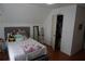 Bedroom with sloped ceilings featuring a bed, dresser, and closet with open door at 615 Old Johnson Rd, Lawrenceville, GA 30045