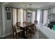 Dining room featuring a dark wood table, six chairs, a modern chandelier, and gray curtains at 615 Old Johnson Rd, Lawrenceville, GA 30045