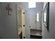 The entryway is decorated with a cross and has a view of the front door and powder room at 615 Old Johnson Rd, Lawrenceville, GA 30045