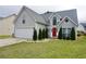 Charming two-story home with a manicured lawn, attached garage, and inviting red front door at 615 Old Johnson Rd, Lawrenceville, GA 30045