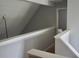 Hallway with white banister and neutral walls, providing access to multiple areas at 615 Old Johnson Rd, Lawrenceville, GA 30045