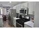 Well-lit kitchen features stainless steel appliances, white countertops, and light gray cabinets at 615 Old Johnson Rd, Lawrenceville, GA 30045
