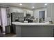 Modern kitchen with stainless steel appliances, gray cabinets, and white countertops with an open layout at 615 Old Johnson Rd, Lawrenceville, GA 30045
