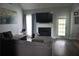 Bright living room with a large television, fireplace, hardwood floors and comfortable sectional sofa at 615 Old Johnson Rd, Lawrenceville, GA 30045