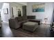 Spacious living room features a gray sectional sofa, a painting, and dark hardwood floors at 615 Old Johnson Rd, Lawrenceville, GA 30045