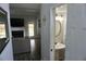The view of a powder room features a pedestal sink, a round mirror, and vanity lighting at 615 Old Johnson Rd, Lawrenceville, GA 30045
