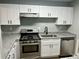 Updated kitchen with white cabinets, stainless steel appliances, and granite countertops at 907 River Run Dr, Atlanta, GA 30350