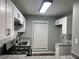 Bright kitchen featuring white cabinets, granite countertops, and stainless steel appliances at 907 River Run Dr, Atlanta, GA 30350