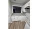 Stylish kitchen pass-through with granite countertops, white cabinets, and modern fixtures at 907 River Run Dr, Atlanta, GA 30350