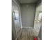 Hallway featuring recently installed wood-style vinyl floors providing access to two bedrooms in the home at 912 Holden Ln, Atlanta, GA 30349