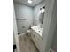 Compact powder room with modern vanity, stylish mirror, and gray walls at 912 Holden Ln, Atlanta, GA 30349