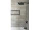 Modern shower featuring gray tiling and a black rainfall shower head at 912 Holden Ln, Atlanta, GA 30349