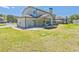View of the backyard showing the house's rear exterior and covered patio at 125 Leverett Ct, Fayetteville, GA 30215