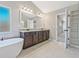 Bathroom featuring soaking tub, double vanity with granite counters, and tiled floors at 125 Leverett Ct, Fayetteville, GA 30215