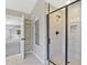 Modern bathroom featuring glass-enclosed shower with tile surround and built-in shelving at 125 Leverett Ct, Fayetteville, GA 30215