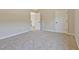 Bedroom featuring neutral paint, plush carpeting, and multiple entry points at 125 Leverett Ct, Fayetteville, GA 30215