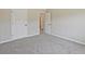 Carpeted bedroom showing an open door with a view to the ensuite bathroom at 125 Leverett Ct, Fayetteville, GA 30215