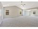 Spacious primary bedroom featuring vaulted ceilings, neutral paint, plush carpeting, and ample natural light at 125 Leverett Ct, Fayetteville, GA 30215