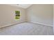 Bright bedroom offers plush carpeting, neutral walls, and natural light from window at 125 Leverett Ct, Fayetteville, GA 30215