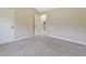 Carpeted bedroom showcasing an open doorway leading to another room with stairs at 125 Leverett Ct, Fayetteville, GA 30215
