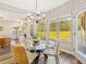 Inviting breakfast nook with a glass table, stylish chairs, and views of the wooded backyard at 125 Leverett Ct, Fayetteville, GA 30215