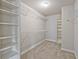 Walk-in closet with wire shelving, rod, and neutral carpeting at 125 Leverett Ct, Fayetteville, GA 30215