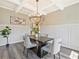 Stylish dining room featuring modern chandelier and wainscoting at 125 Leverett Ct, Fayetteville, GA 30215