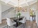 Elegant dining room with wainscoting and a modern chandelier fixture at 125 Leverett Ct, Fayetteville, GA 30215