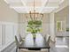 Bright dining room with wainscoting and modern chandelier and hardwood floors at 125 Leverett Ct, Fayetteville, GA 30215