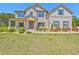 Elegant brick home with manicured lawn, covered porch, and charming landscaping at 125 Leverett Ct, Fayetteville, GA 30215