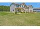 Inviting home with a covered porch and lush green lawn at 125 Leverett Ct, Fayetteville, GA 30215